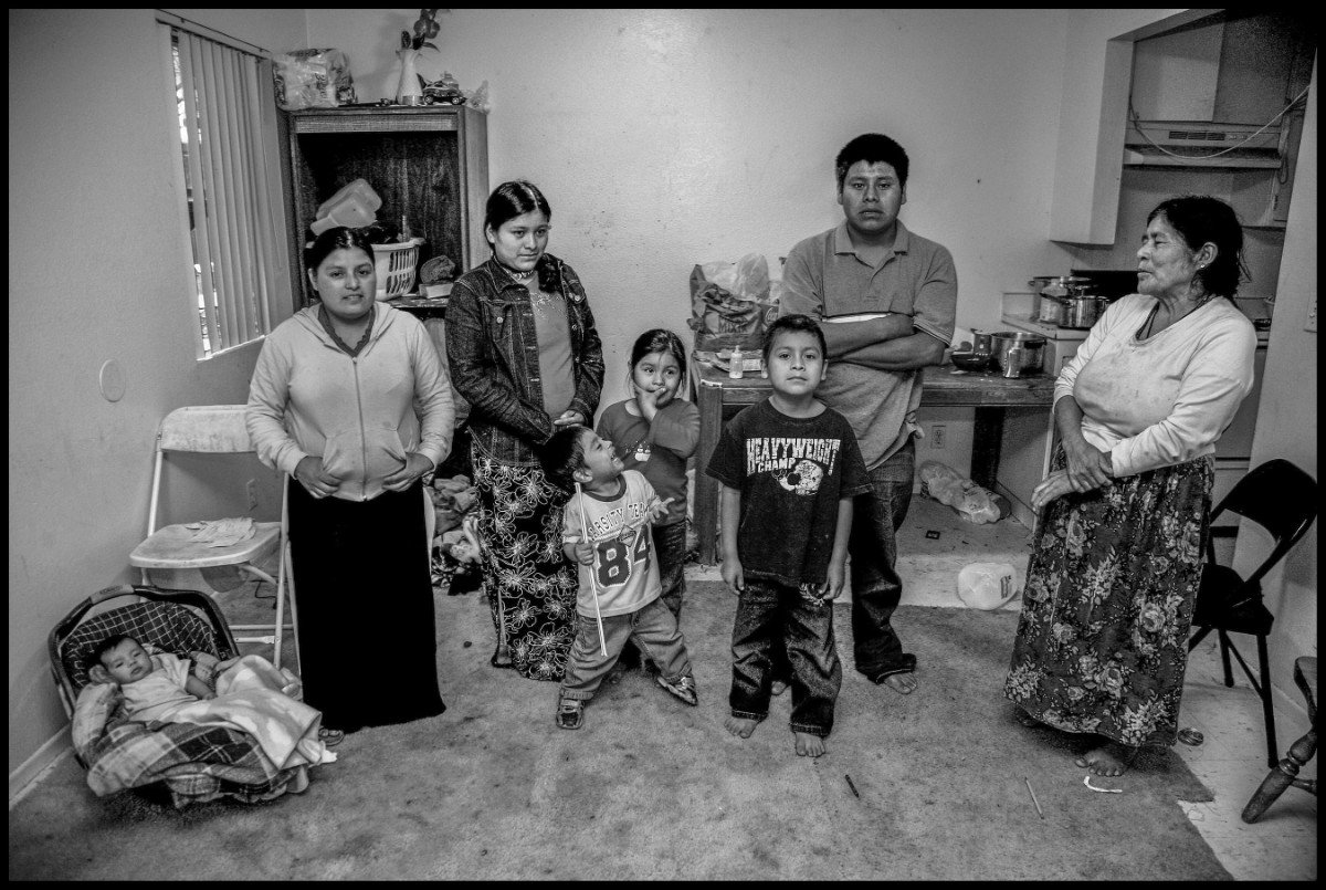 In the spring and summer a Mixtec family, living in an apartment complex in Santa Maria, works picking strawberries. Leobarda Hernandez, her daughter Rosa Seferino, and their children Carolina, Michael, Elena, Porfirio and Jorge Garcia. (Photo © David Bacon)
