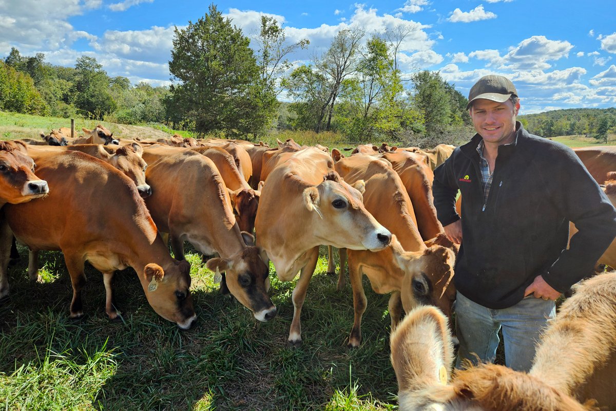 Preston Green stands among Big Bottom Milk Company’s herd of curious Jersey cows on the farm outside of Forest City, North Carolina. Less than three weeks before, the pasture had been swamped by Tropical Storm Helene. (Photo credit: Daniel Walton)