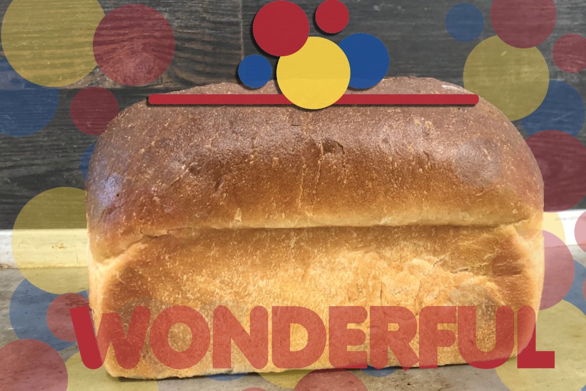 a full loaf of white bread made from milled grains, with the word wonderful in red over it and some colorful dots above it